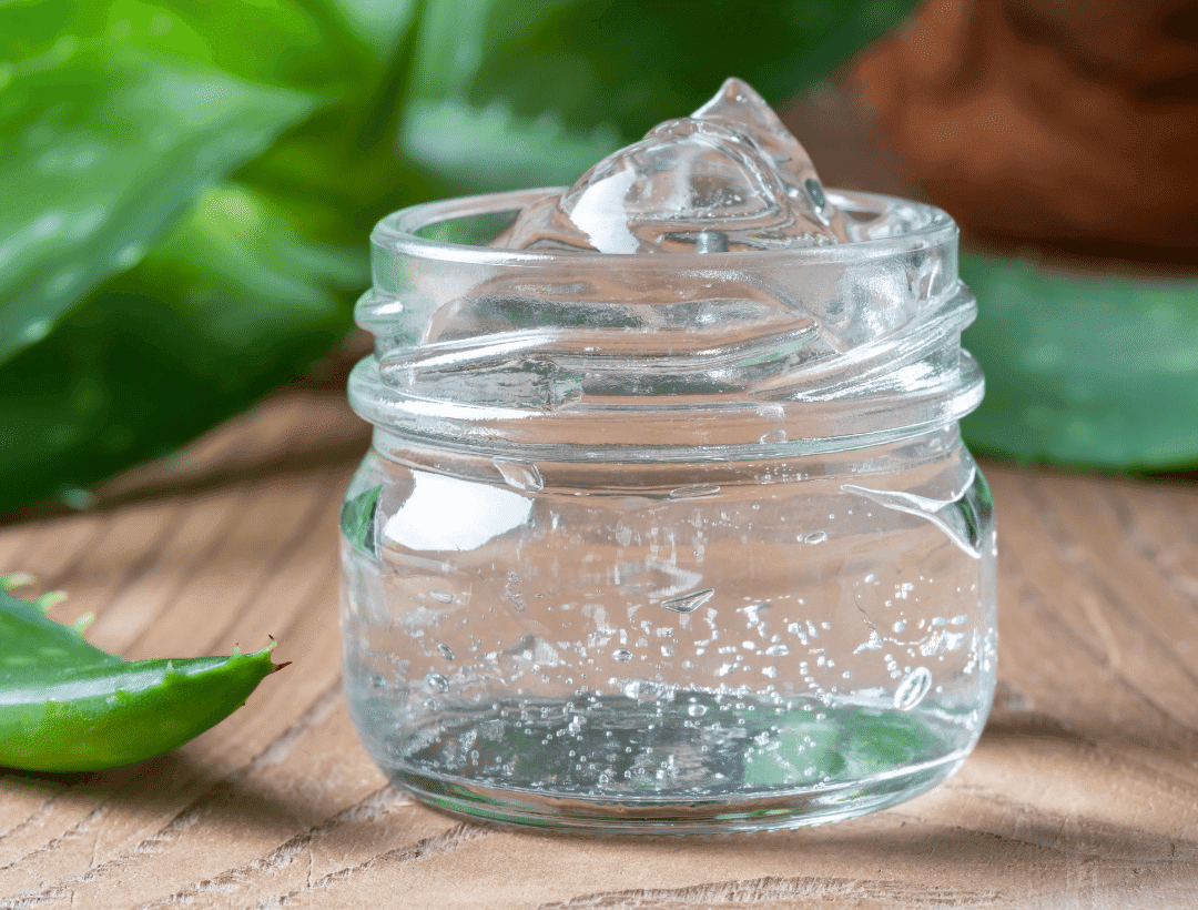 Aloe vera gel in a transparent container on a wood table