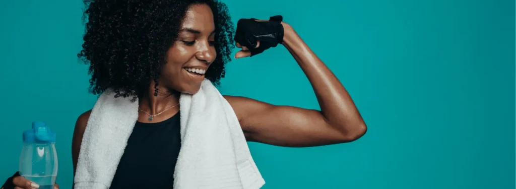 A young fit black woman flexing her biceps