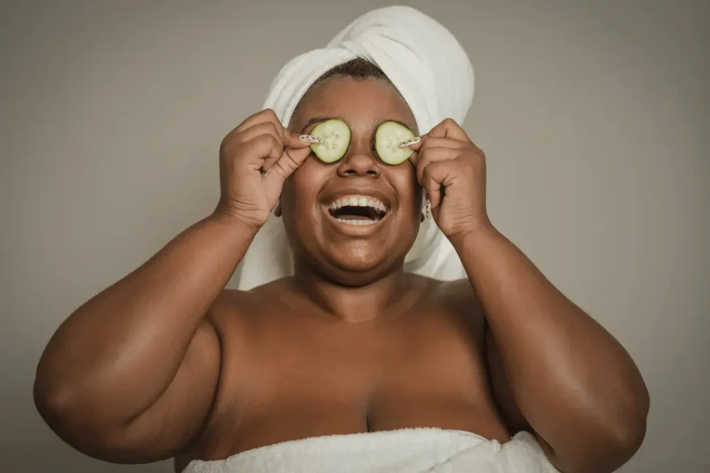 A woman with cucumber slices on her eyes representing the best organic anti aging skin care